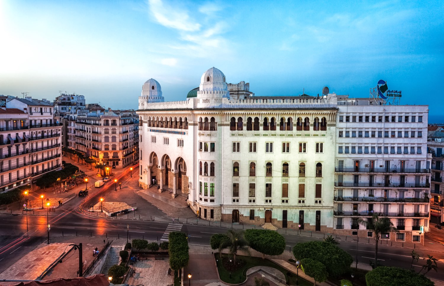 La Grande Poste d'Alger at dusk, with the surrounding streets of central Algiers.